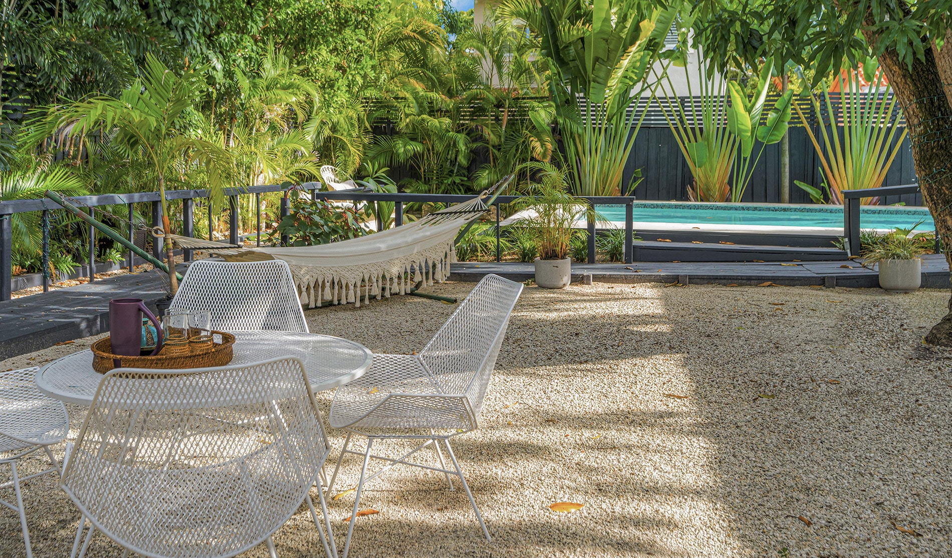 Coconut Grove home renovation - backyard with a pool and seating area, designed by Beatrice Leupold Coconut Grove home renovation - backyard with a pool and seating area, designed by Beatrice Leupold